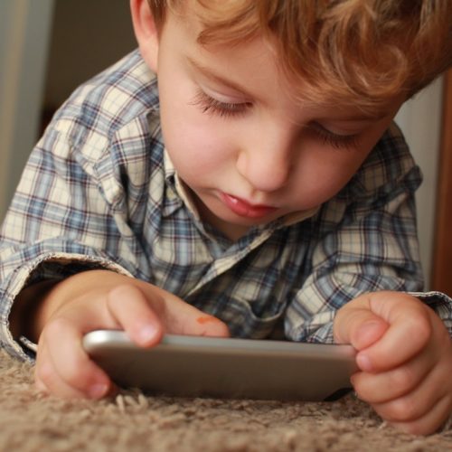Young boy on telemedicine visit via smartphone