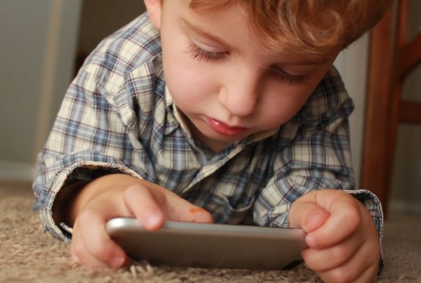 Young boy on telemedicine visit via smartphone