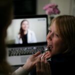 caregiver checking child's tonsils