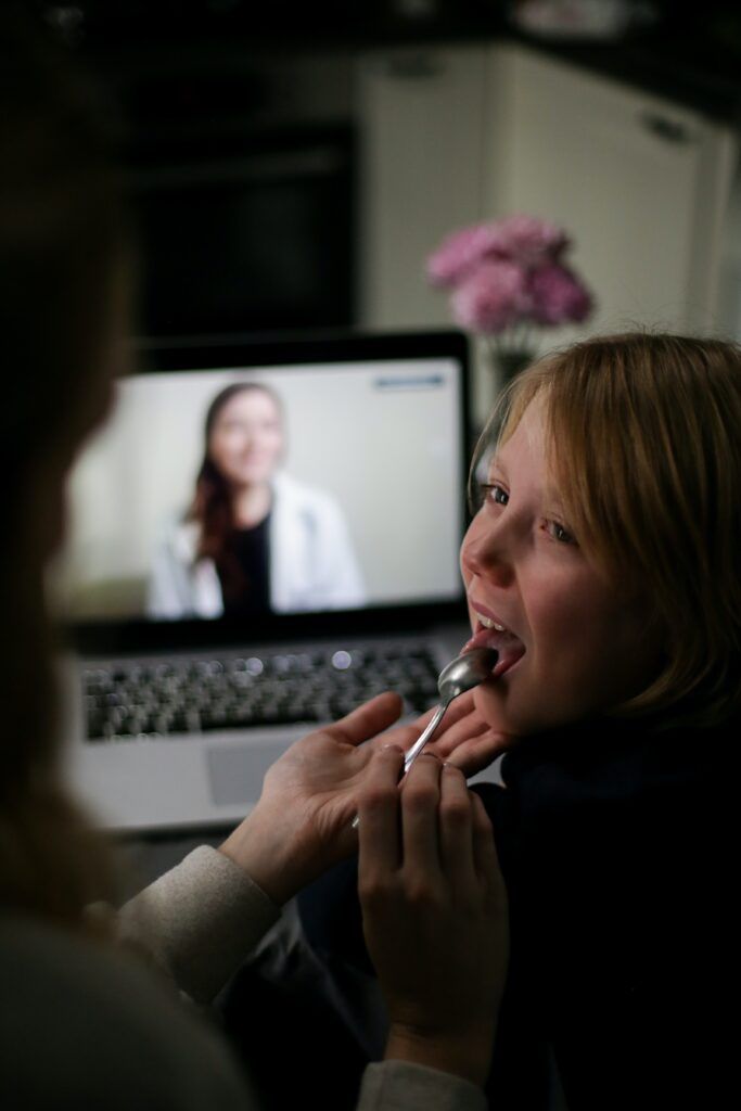 caregiver checking child's tonsils