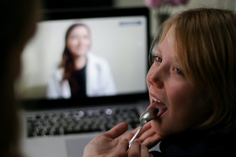 caregiver checking child's tonsils