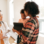 pediatrician with patient and caregiver