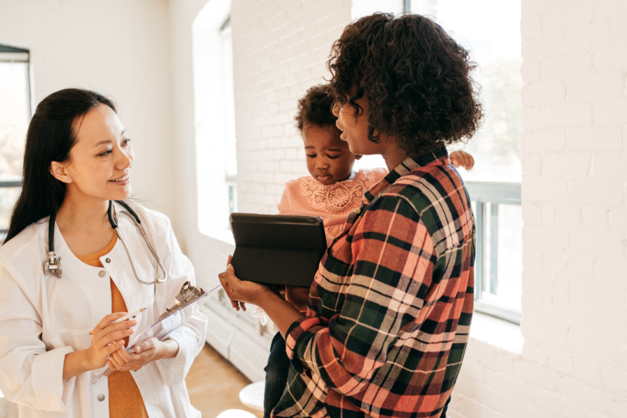 pediatrician with patient and caregiver