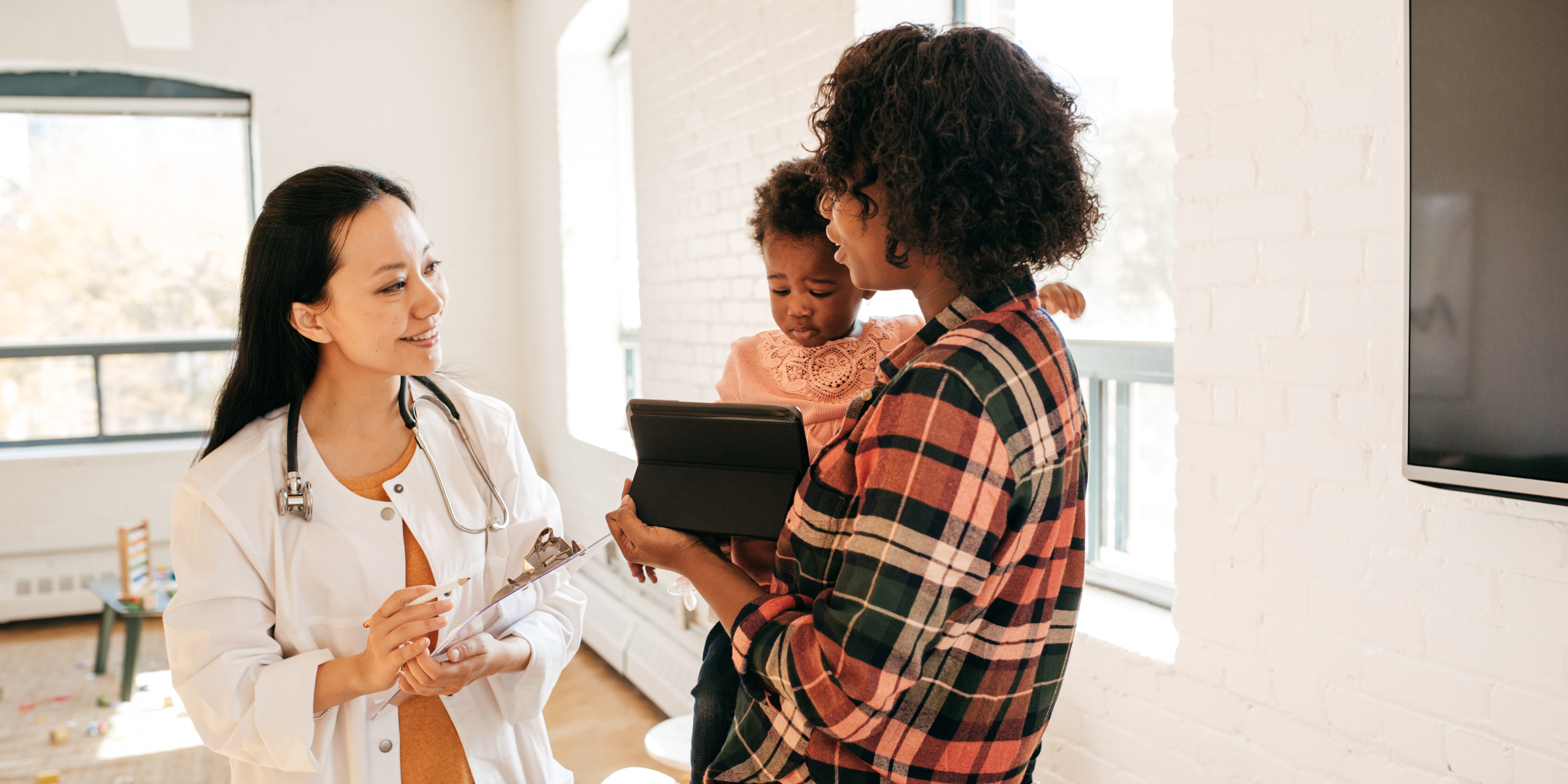 pediatrician with patient and caregiver